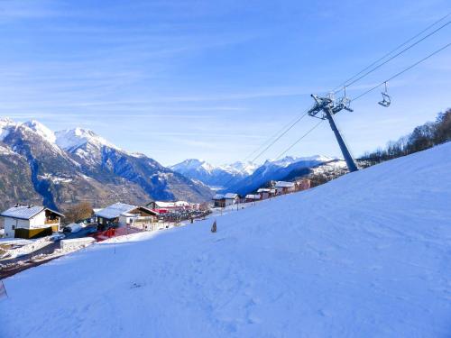 a person riding a ski lift on a snow covered slope at Holiday Home Chalet Ninette by Interhome in Eischoll