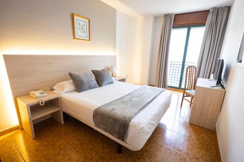 a hotel room with a bed and a television at Hotel Madrid in Pontevedra