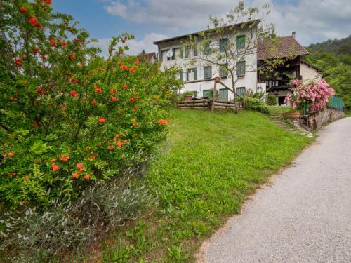 an old house with flowers in front of it at Holiday Home La Predaia by Interhome in Barcis