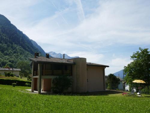 a small house in a field with a green field at Holiday Home Terry by Interhome in Olivone
