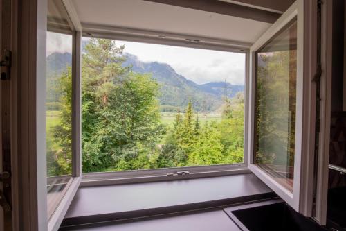 a window with a view of a mountain at "Haus am Illufer" Ihr Smart-Alpin-Home in Bludenz in Bludenz