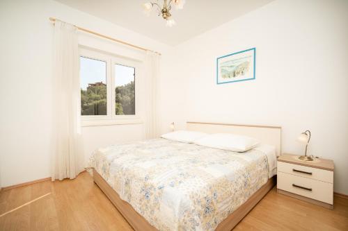 Ένα ή περισσότερα κρεβάτια σε δωμάτιο στο Apartmani Zlata