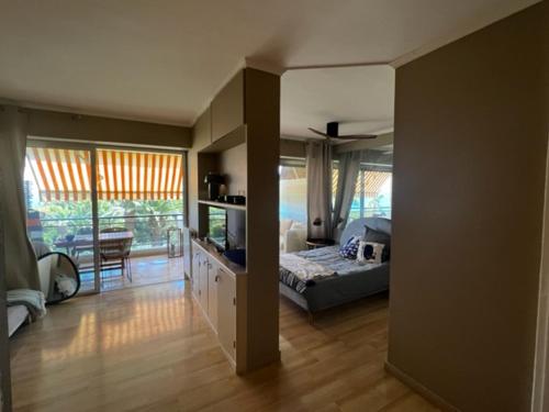 a bedroom with a bed and a television in it at Splendid sea view 1 Bedroom access to the beach and swimming pool in Vallauris