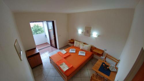 a living room with a couch and a table at Apartments and rooms Bova in Baška