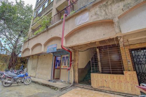 a pink hose attached to the side of a building at Hotel Della Comfort near Ambreshwar Shiv Mandir, Ambernath in Ambernath