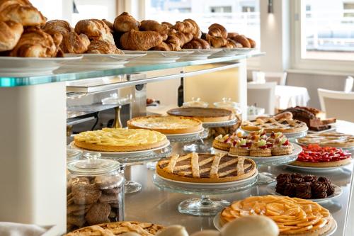 a buffet line with pies and pastries and breads at Grand Hotel Spiaggia in Alassio