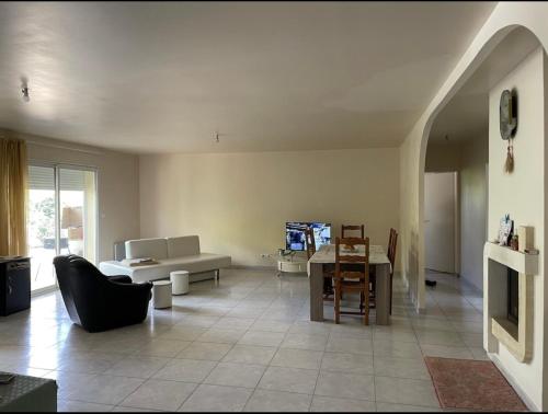 a living room with a couch and a table at Au pied de Lascaux in Montignac