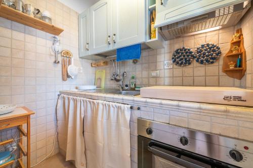 a kitchen with a sink and a counter with towels at Adriana's house in Buggerru