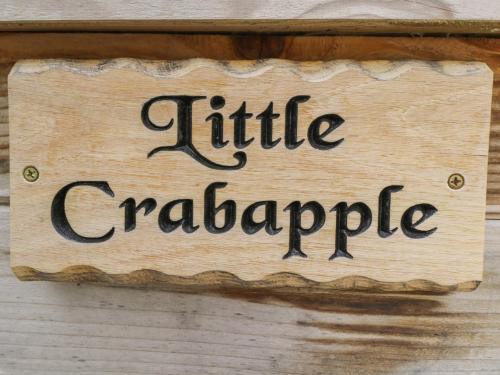 a sign that reads little cartaparide hanging on a wall at Little Crabapple in Swanage