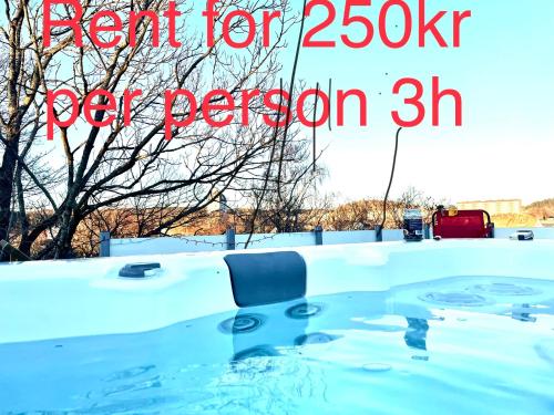 a hot tub covered in snow with the words start for per person at Lyxig Villalägenhet i centrala Uddevalla - Spabad in Uddevalla