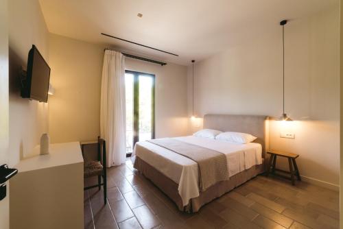 a bedroom with a large bed and a window at Yasemi in Argostoli