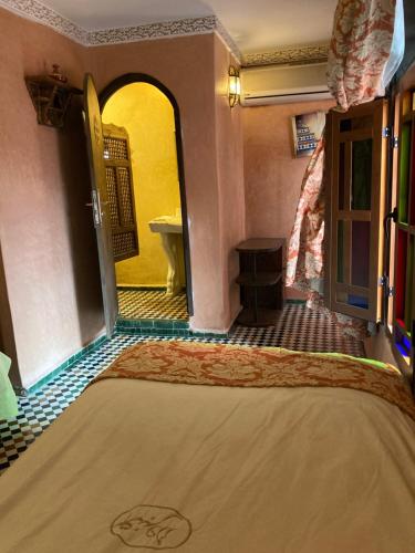 a room with a bed and a bathroom at Dar Anebar in Fès