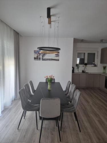 a dining room with a black table and chairs at Villa Madison in Posedarje