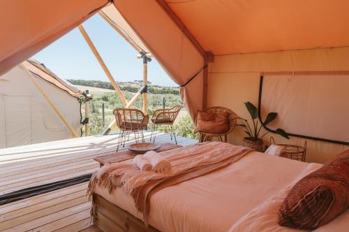 a bedroom with a bed and a large window at Dreamsea Surf Guest House in Sintra