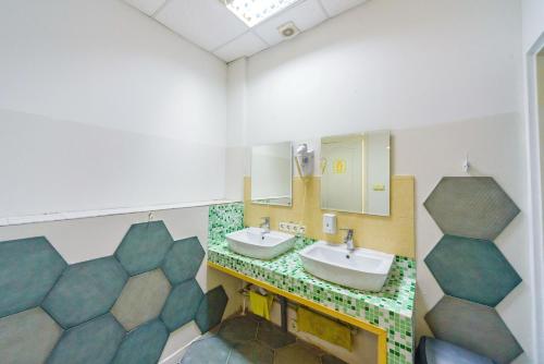 a bathroom with two sinks and a mirror at Traveler's haven in Odesa