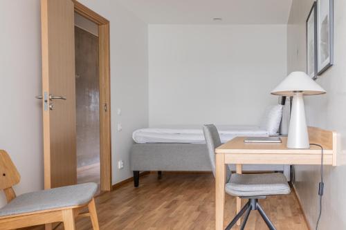 a small room with a desk and a bed at The More Hotel Västra Hamnen in Malmö