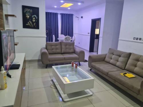 Sala de estar con 2 sofás y mesa en Plistbooking 3 Bedroom Duplex, City View Estate en Pakuro