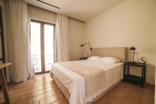 a bedroom with a bed and a large window at Yasemi in Argostoli