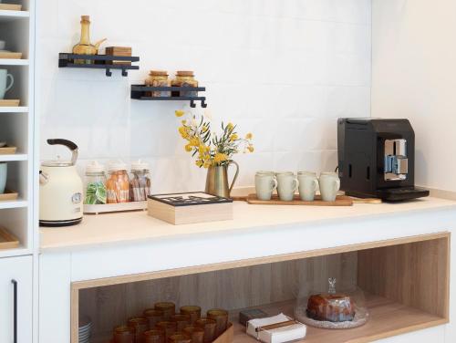 a kitchen with a counter with a coffee maker on it at LD Convento Cister in Málaga
