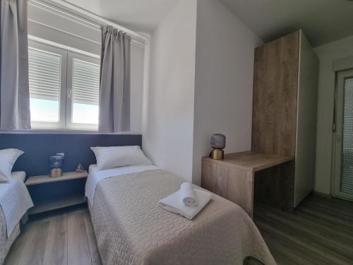 a bedroom with two beds and a window at Villa Madison in Posedarje