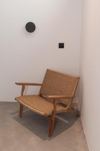 a wicker chair sitting next to a table at Stremma Naxos in Aliko Beach