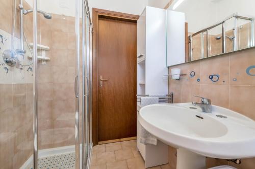 a bathroom with a sink and a shower at Alle Rive apartment in Salò