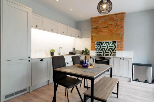 a kitchen with a table and chairs in a room at The Kitbag in West Runton