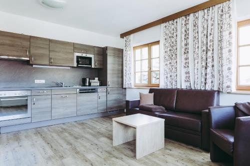 a living room with a couch and a table at Andis Almdorf in Sölden