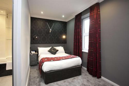 a bedroom with a bed and a window at St James Hotel; BW Premier Collection in Nottingham