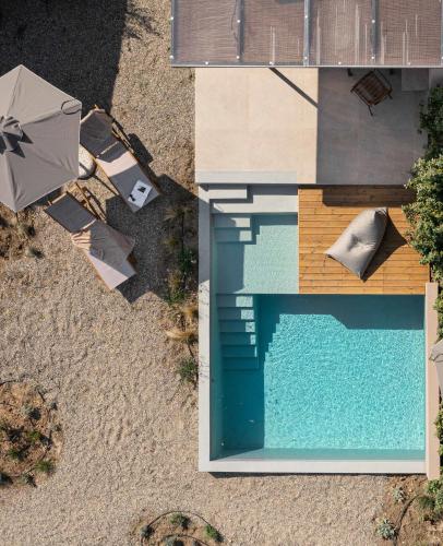 an overhead view of a swimming pool with an umbrella at Etheres in Nikiti