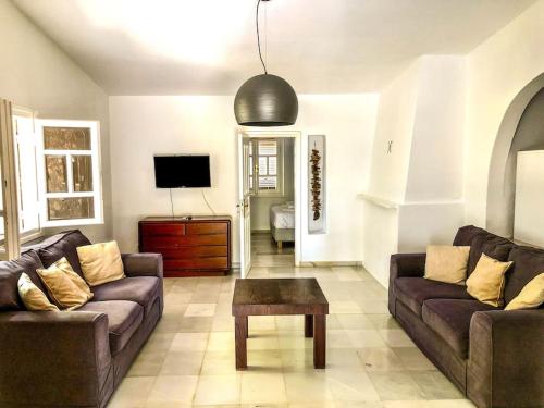 a living room with two couches and a coffee table at Villa Artemis in Small Kounoupi Porto Heli in Porto Heli
