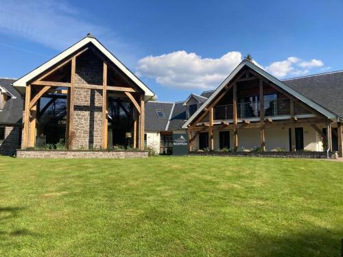 a large house with a lawn in front of it at The Loch Lomond Guesthouse in Balloch