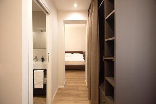 a hallway leading to a bedroom with a bed at Palazzo Bellocchi - Suites & Apartments in Brindisi