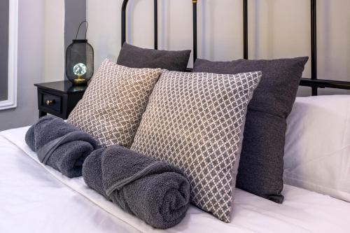 a pile of pillows sitting on a bed at The Venue Hostel Boutique in Valencia