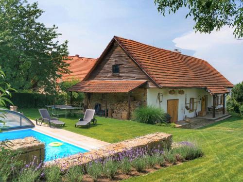 a cottage with a swimming pool in the yard at Holiday Home Libel by Interhome in Libel