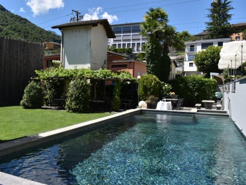 a swimming pool in the backyard of a house at Apartment Capriccio 14 Balcony by Interhome in Intragna
