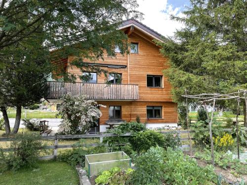 a wooden house with a garden in front of it at Apartment Ilse EG by Interhome in Fieschertal