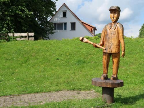 a statue of a boy holding a baseball bat at Apartment Am Ostedeich-1 by Interhome in Oberndorf