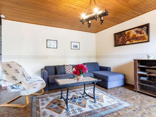 a living room with a couch and a table at Holiday Home Le bois bourdin by Interhome in Pontorson
