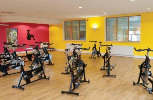 a gym with a bunch of exercise bikes in a room at Devon Hills in Paignton