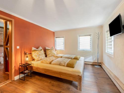 a bedroom with a bed and a flat screen tv at Holiday Home Dunja by Interhome in Hain