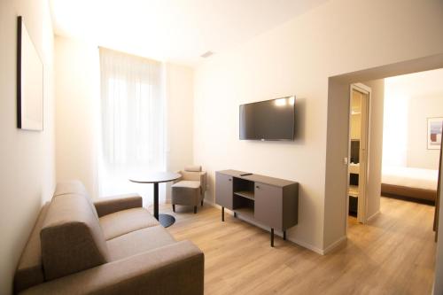 a living room with a couch and a tv at Palazzo Bellocchi - Suites & Apartments in Brindisi