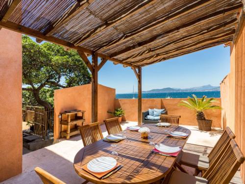 a table on a patio with a view of the ocean at Villa La Madrague by Interhome in Hyères