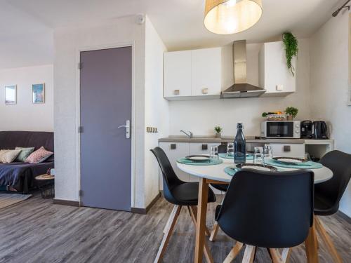 une cuisine et une salle à manger avec une table et des chaises dans l'établissement Apartment Babel by Interhome, à Canet