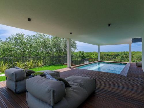 a living room with a couch and a swimming pool at Holiday Home Villa Valle by Interhome in Bale