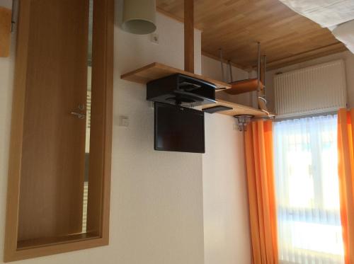 a kitchen with a microwave and a mirror and a window at Gasthof Hotel Bauer in Hersbruck