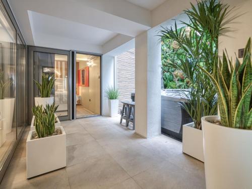 a corridor with potted plants in a building at Apartment Deluxe Bellissima by Interhome in Crikvenica