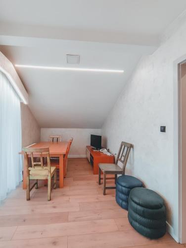 a room with a table and chairs and a desk at Motel Almy in Zenica