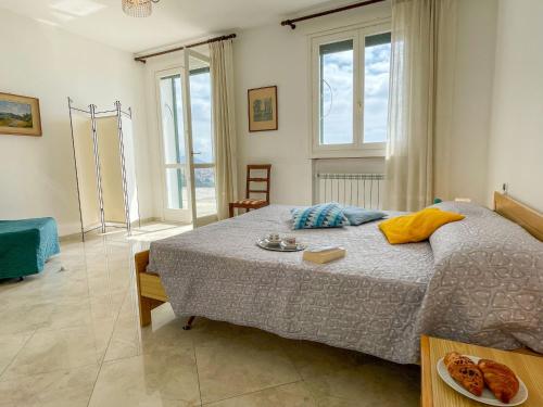 a bedroom with a bed with a plate of food on it at Apartment Villa Panoramica by Interhome in Poggi