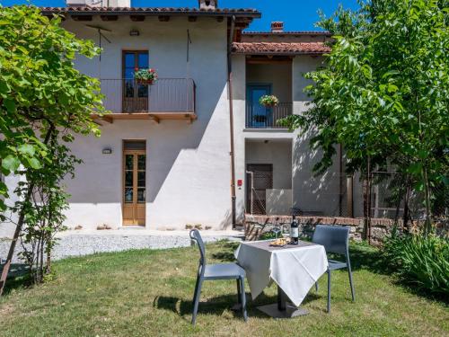 a table and chairs in front of a house at Apartment L'appartamento del Monastero by Interhome in Dronero